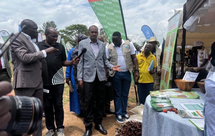 Minister of Agriculture, Animal Industry and Fisheries, Frank Tumwebaze tours the Food Rights Alliance stall, during the World Food Day celebrations at the National Agricultural Research Organisation (NARO) in Mbarara City, on Friday.